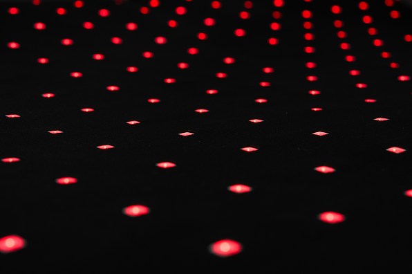 Array of red LED lights showing the photobiomodulation (PBM) technology used in the Buddie Beddie pet therapy bed for dog pain relief and wellness