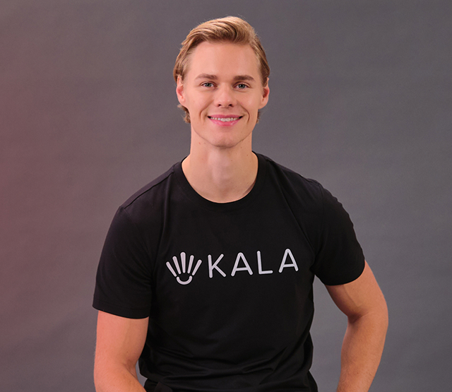 Portrait of Cam Stajer, the founder of Kala Therapy and Buddie, wearing a black Kala branded t-shirt.